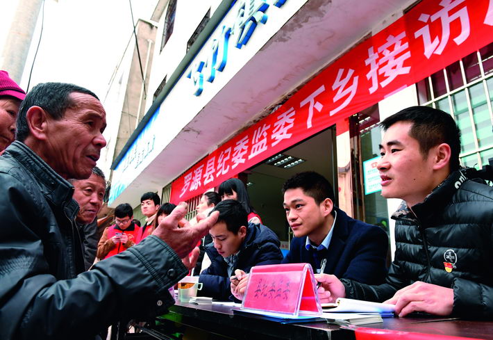 Officials from the Discipline Inspection and Supervisory Commission of Luoyuan County in Fuzhou City, Fujian Province, talk to local villagers.  Xinhua